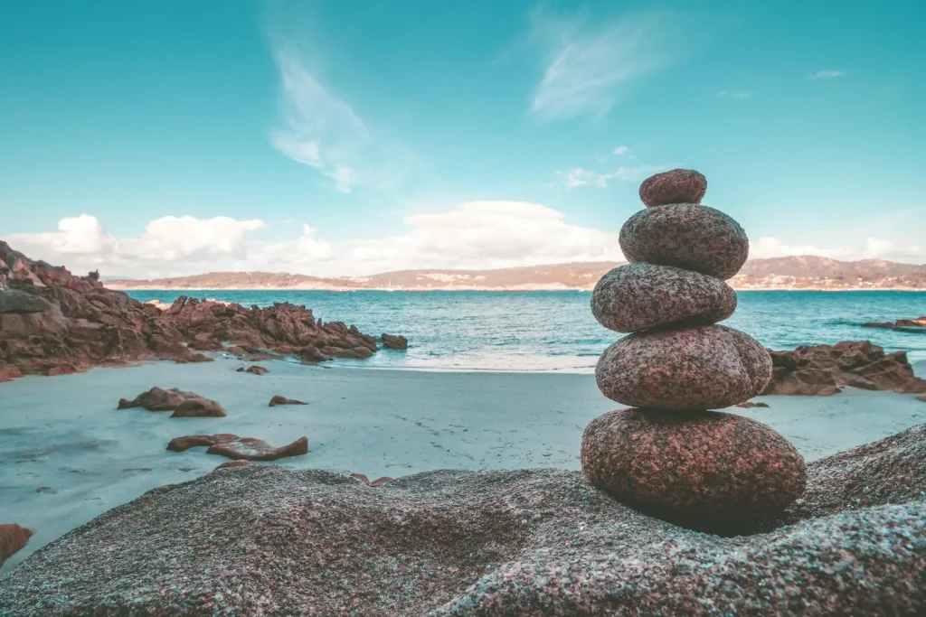 Cairn of balanced stones on a beach — symbol of stability and foundation